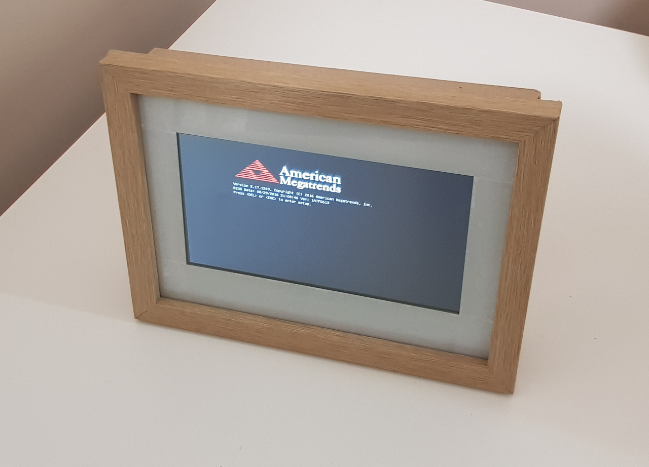 A digital photo frame showing an American Megatrends Power-On Self-Test screen